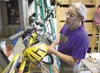 Tom Hale checks the weight on his bike while it is almost fully
loaded. It weighed in at 79 lbs. (ROBERT DeBERRY/Frontiersman) Robert DeBerry