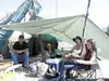Mike Morgan of Talkeetna, left, and Jason Scruggs and Selina
Scruggs of Willow were protected against sun or rain at their camp.
Photo by Steve Kadel/Frontiersman