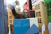 King Kong emerges from behind a city skyline made from cardboard boxes on the Sutton Library float during the 2013 Alaska State Fair Parade. The library took first-place honors with its float