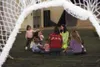 A group of home-school children and their parents sit on the
artificial turf at the Multi-Use Sports Complex in Wasilla playing
games for their hour of physical activities. JOEL
DAVIDSON/Fron