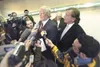 ROBERT DeBERRY/Frontiersman file photo Former state Rep. Vic
Kohring, center, is surrounded by news reporters during his 2007
bribery trial. As the state prepares to retry Kohring, his attorn