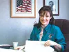 Sarah Palin, early in her six-year career as Wasilla's mayor,
signs documents at her desk. As one of two recently appointed to
the Alaska Oil and Gas Conservation Commission, Palin is delving