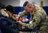 Maj. Gen. Torrence Saxe, adjutant general of the Alaska National Guard and commissioner of the Department of Military and Veterans Affairs, pins the Alaska Heroism Medal on Cpl. Bruce Boolowo