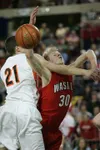 Wasilla Warrior Connor Devine draws a foul as he drives to the
basket for two points during the first period of the Championship
match-up against the West High Eagles Wednesday in
Anchorage.(