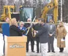 Mat-Su College Director Talis Colberg and Palmer Mayor DeLena Johnson stand in front of a crowd of university system dignitaries Friday to cut a ribbon marking the beginning of construction o