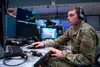 Alaska Air National Guard Senior Airman Kenyon DePriest, 176th Air Defense Squadron surveillance technician, monitors Alaska airspace March 14, 2023, in the Regional Air Operations Center at 