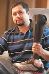 Iraq war veteran Tyker Hall sits in his home with his prosthetic leg. Hall lost his leg just below the knee when the vehicle he was riding in hit an improvised explosive device in Iraq. ROBER