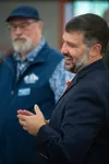 Stephen Jellie, Palmer's new city manager, speaking with attendees at the reception thrown in his honor at The Depot, Aug. 28, 2024, in Palmer, with Mayor Steve Carrington standing behind. J.