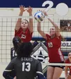 Wasilla's Bella Hays (left) an Josi Schachle team up for a block Thursday, Nov. 7, 2019, at the Northern Lights Conference tournament at Soldotna High School in Soldotna, Alaska. Joey Klecka/