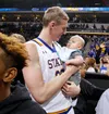 Connor Devine from South Dakota State celebrates with his son Daniel after the Jackrabbits defeated the North Dakota State Bison in the 2016 Summit League Championship March 8, 2016, in Sioux