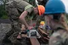 Alaska Army National Guard Pfc. Alex Engan, assigned to the 910th Engineer Support Company, uses an electric saw to cut boards for a bunker at Observation Post Cole at Joint Base Elmendorf-Ri
