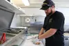 Matt Shaughnessy prepares a sandwich during the grand opening of the Palmer Towne Food Court. Jacob Mann/Frontiersman
