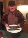 St. John Lutheran Church pastor Jonathan Rockey shows off a couple of the fish he caught last week while fishing with his grandchildren. Ice fishing with kids can teach great patience, writes
