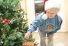 ROBERT DeBERRY/Frontiersman Helen Munoz hangs a Christmas
ornament on one of two Christmas trees that have been put up for
the "Light Up A Life" fundraiser for the non-profit arm of the
Mat-S