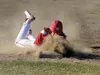 Wasilla senior Zach Garnett slides throw a cloud of dust into third base early in Wasilla's 11-1 win over Soldotna in the Southcentral Conference championship game Friday at Houston High Scho