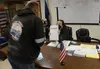 Poll worker Margaret Schorey explains the two-sided Aug. 16, 2022 ballot to a voter at the polling place in Juneau's downtown fire station. James Brooks/Alaska Beacon