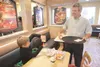 ROBERT DeBERRY/Frontiersman Elias Stratton, 10, gives his cookie
dough Blizzard the upside down test Friday as Dairy Queen Vice
President of Operations Dan Cropp watches during the grand open