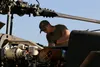 U.S. Army Spc. Alex Davis, UH-60 helicopter repairer with Bravo Company, 1-137th Assault Helicopter Battalion, 28th Expeditionary Combat Aviation Brigade, performs routine maintenance on a UH