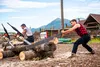 Ralphie Hattershide competes against his former coach, Rob Waibel, in the log sawing event Lumberjack Show at the Alaska State Fair on Wednesday evening. KATIE STARK
