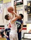 Houston's Cameron Wyrick works to shoot over the reach of Redington's Jahzeah Williams during a win over the Huskies Tuesday at Houston High. Courtesy of Ron Jones/matsusports.net