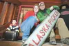 Becky Green and Kelly Turney sit on the steps of their new Alaska Picker store in the old Fort Green building along the Palmer-Wasilla Highway. The picking duo is featured in a new National G