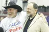 ROBERT DeBERRY/Frontiersman Safari Club President Eddie Grasser
puts his arm Rep. Wes Keller Tuesday at the Wasilla Multi Use
Sports Complex during the Civic Festival.