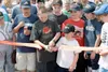Justin and Taylor Roth, members of Palmer Little League squads,
cut the ribbon to commemorate the official opening of the new
facilities at Sherrod Elementary on Saturday. Officials used
reso