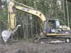 City of Houston employee Curt Ensminger operates a backhoe to level out ground in preparation for a gravel parking area on Zero Lake Road to serve nearby trails that run to Hatcher Pass. ANDR