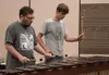 University of Iowa percussion professor Dan Moore plays a song on the marimba with Dimond High School student Ethan Combs between percussion camp classes at Colony Middle School on Wednesday.