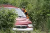 A Matanuska Towing employee helps guide a minivan as its pulled to Bogard Road hours after an accident Sunday. One person died in the single-car accident. JEREMIAH BARTZ/Frontiersman