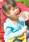 ROBERT DeBERRY/Frontiersman Li Mei Fiske, 5, works on her giant
lollipop Monday afternoon at the Alaska State Fair. Fair food is
always a crowd favorite and with more than 60 food vendors at 
