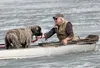 Rodney Priebe holds a rope attached to a mastiff that fell through the ice of Seymour Lake on Friday, April 15, 2016. Priebe and Mat-Su Borough Animal Care and Control officer Nick Uphus padd