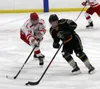 Colony senior Foster Riekena, right, tries to move the puck past the reach of Wasilla senior Wyatt Moore during a 6-3 win over the Warriors earlier this season. Courtesy of Bruce Eggleston/ma