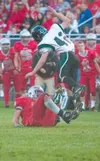 ROBERT DeBERRY/Frontiersman Colony senior Nate Wolfe is tangled
up with Wasilla senior David Green.