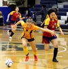 Team Alaska's Shayla Lee keeps possession of the ball during a pool play win over Team Nunavut. Alaska went on to win the U18 girls gold medal. Jeremiah Bartz/Frontiersman