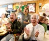 ROBERT DeBERRY/Frontiersman Wasilla resident Raquel Lane,
center, stands and cheers as Robbie Lane, front left and Tom Myhre
applaud during Gov. Sarah Palin’s speech at the Republican Nationa