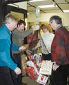 Jerry Moses, Steve Herold, Brandi Nelson and Gary Gearhart weigh
food during last week's food drive competition. JEN
RANSOM/Frontiersman.