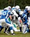 Jake Huen, Colby Yuill and a gang of Palmer tacklers stop Colony
running back Shawn Olivera for a short gain during the first half
of Palmer's 20-13 win over the Knights at Machetanz Field on