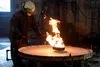 John Farley, director of fire test operations at the Naval Research Laboratory, reintroduces fire to a 28-square-foot container that was just sprayed with a fluorine-free foam to put out a ga