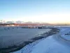 The snow-covered shoreline and gray waters of Knik Arm appear
serene, with Anchorage in the background. If a proposed bridge were
constructed, the municipality of Anchorage and the Mat-Su wou