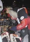 Aily Zirkle thanks her team after they finished second in the 2013 Iditarod Trail Sled Dog Race. CHERYL METIVA/Frontiersman