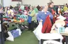 Volunteers and patrons sort through some of the more than two tons of clothing Turn A Leaf Thrift Store donated to the fourth annual Mat-Su Valley Project Homeless Connect event Jan. 29 at th