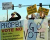 Opponents of Proposition B-1 urge their cause at the intersection of Palmer-Wasilla Highway and Parks Highway on Tuesday. (MATT HICKMAN/Frontiersman)