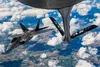 A U.S. Air Force F-22 Raptor aircraft assigned to the 90th Fighter Squadron, Joint Base Elmendorf-Richardson, Alaska, departs after receiving fuel from a U.S. Air Force KC-135 Stratotanker ai