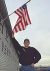 Sergiy Korelov speaks of his new country with zeal and when he
was asked to pose for a photograph, he eagerly jumped up on a chair
to be near an American flag. Photo by EOWYN LeMAY
IVEY/Front
