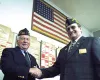 VFW Junior Vice Commander-In-Chief John Furgess of Tennessee
shakes hands with Wasilla VFW Post 9365 Commander Bill Dishon on
Friday during a break in the men's state VFW convention. Photo by