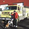 Meadow Lakes volunteer firefighter Michieal Salmon attends the
grand opening of Station 7-2 last weekend with her two dogs --
Streak and Treasure the Dalmatian. Treasure is the station's
masc