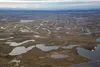 Lakes and connecting streams in the northeastern part of the National Petroleum Reserve in Alaska are seen from the air on June 26, 2014. A newly published study examines oil industry use of 