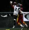 John Wagner/Fairbanks Daily News-Miner West Valley's Willie G.
Clark Jr., background, reels in a one-handed touchdown catch
despite pressure from Colony's Chad Lowery during Colony's 42-13 at