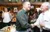 Robbie Lane, left shakes hands with Tom Myhre as Karla Bearisto,
back left watches the end of Gov. Sarah Palin's Speech at the
Republican Nation Convention Wednesday night. More than a hundre